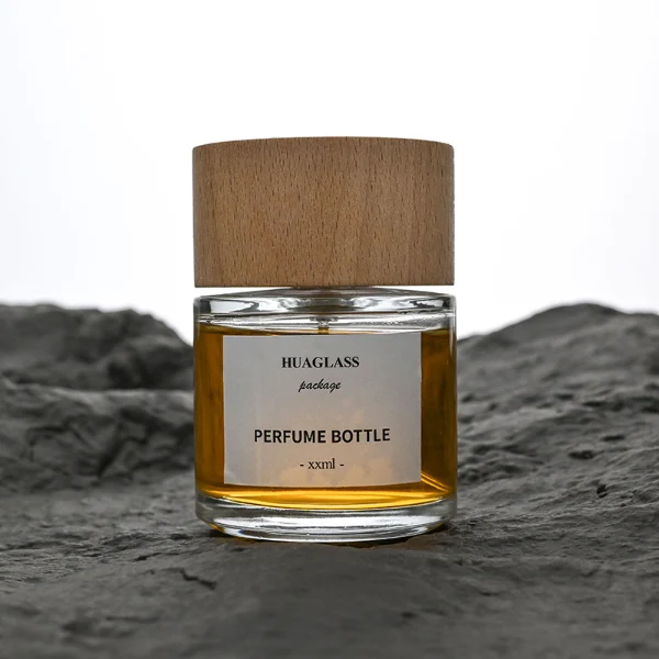 HUA0123 perfume bottle, rounded cylindrical clear glass with outer label, wide wooden cylindrical cap, minimalist modern design, available in 30 ml, 50 ml, and 100 m