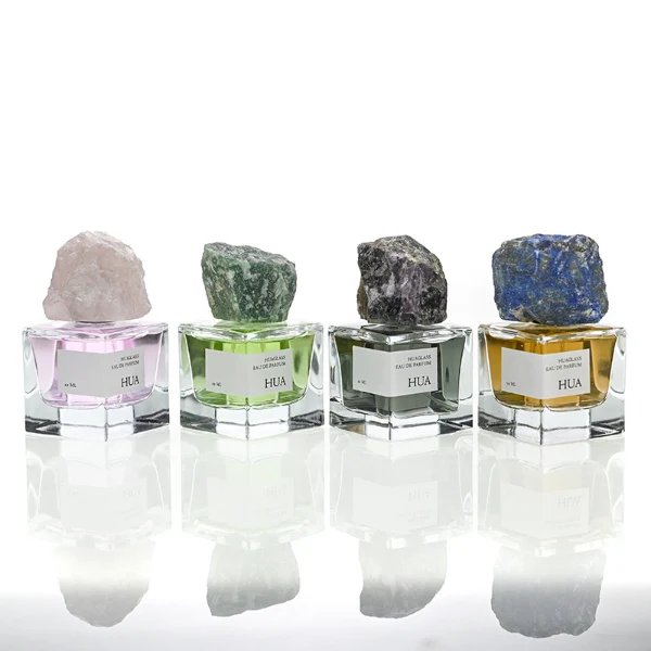 HUA0124 perfume bottle, square clear glass with outer label, irregular crystal stone cap with natural raw texture, contemporary decorative design, available in 30 ml, 50 ml, and 100 ml