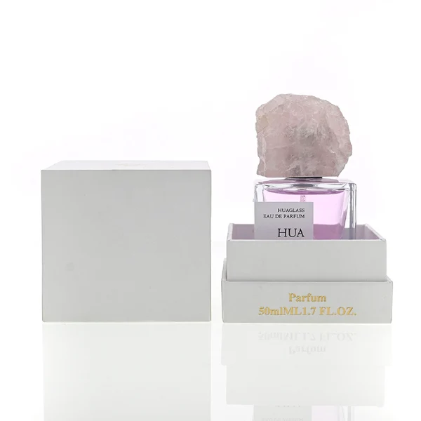 HUA0124 perfume bottle, square clear glass with outer label, irregular crystal stone cap with natural raw texture, contemporary decorative design, available in 30 ml, 50 ml, and 100 ml