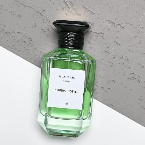 HUA0126 perfume bottle, faceted rectangular clear glass body with liquid, square resin cap, printed logo, contemporary elegant design, available in red, green, yellow, ideal for gifting and daily use.