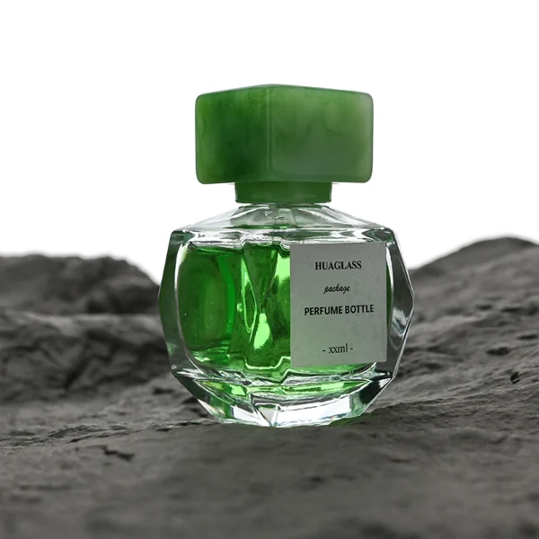 HUA0126 perfume bottle, faceted rectangular clear glass body with liquid, square resin cap, printed logo, contemporary elegant design, available in red, green, yellow, ideal for gifting and daily use.