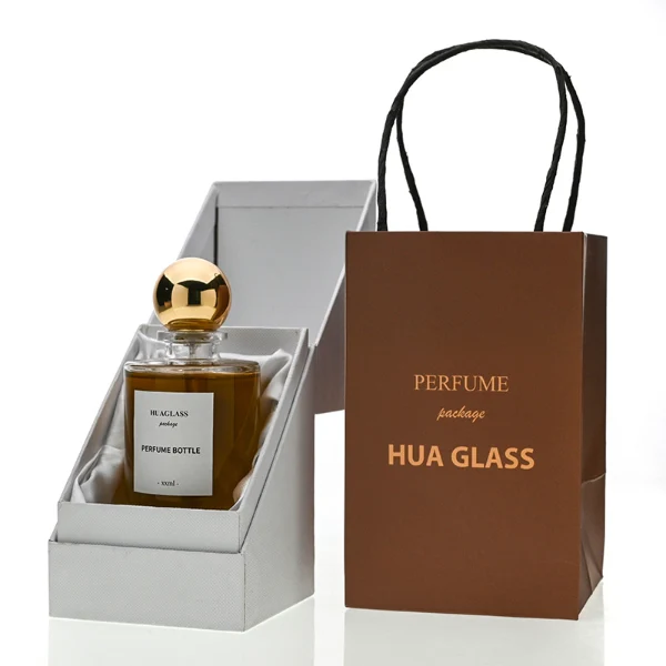 HUA0130 perfume bottle, cylindrical clear glass body with 30 ml, 50 ml, or 100 ml liquid, spherical plastic cap, outer label with printed logo, modern elegant design, ideal for gifting and daily use.