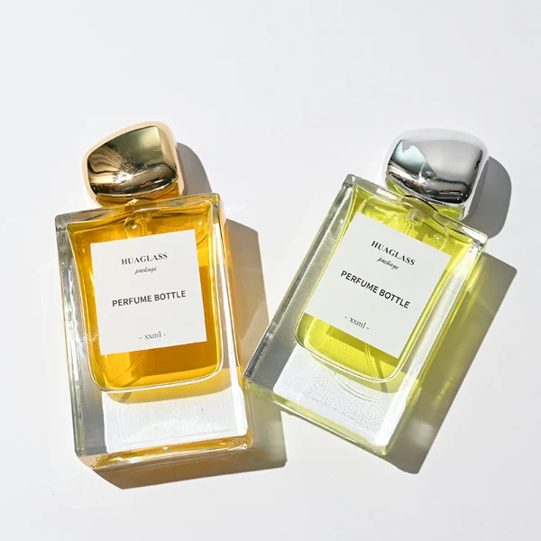 HUA0133 perfume bottle, rectangular clear glass body with 30 ml or 50 ml liquid, irregular-shaped plastic cap, outer label with printed logo, modern elegant design, ideal for gifting and daily use.