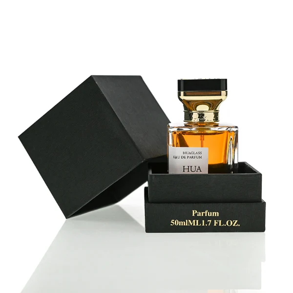 HUA0145 perfume bottle, rectangular clear glass body with 30 ml, 50 ml, or 100 ml liquid, gold funnel-shaped cap with black circular top inset with irregular transparent plastic piece, outer label with printed logo, modern luxurious design, ideal for gifting and daily use.