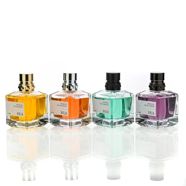 HUA0147 perfume bottle, rectangular clear glass body with 50 ml, 70 ml, or 100 ml liquid, layered ring-shaped plastic cap with diamond-textured base, outer label with printed logo, modern luxurious design, ideal for gifting and daily use.