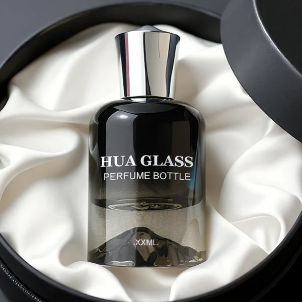 HUA0148 perfume bottle, cylindrical customizable gradient glass body with mountain-shaped base, 30 ml, 50 ml, or 100 ml liquid, irregular cylindrical cap with raised top in gold or silver, outer label with printed logo, modern elegant design, ideal for gifting and daily use.