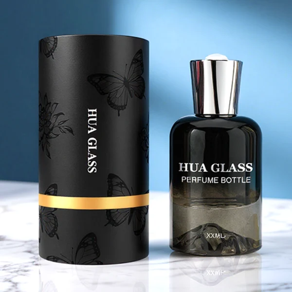 HUA0148 perfume bottle, cylindrical customizable gradient glass body with mountain-shaped base, 30 ml, 50 ml, or 100 ml liquid, irregular cylindrical cap with raised top in gold or silver, outer label with printed logo, modern elegant design, ideal for gifting and daily use.
