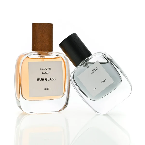 HUA0149 perfume bottle, rectangular clear glass body with 30 ml, 50 ml, or 100 ml liquid, cylindrical wooden cap, outer label with printed logo, modern elegant design, ideal for gifting and daily use.