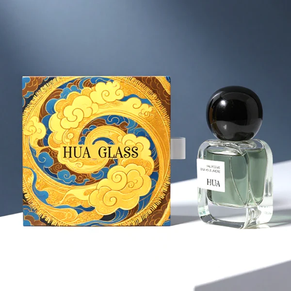 HUA0154 perfume bottle, rectangular clear glass body with 30 ml, 50 ml, or 100 ml liquid, irregular spherical plastic cap with customizable color, outer label with printed logo, modern elegant design, ideal for gifting and daily use.