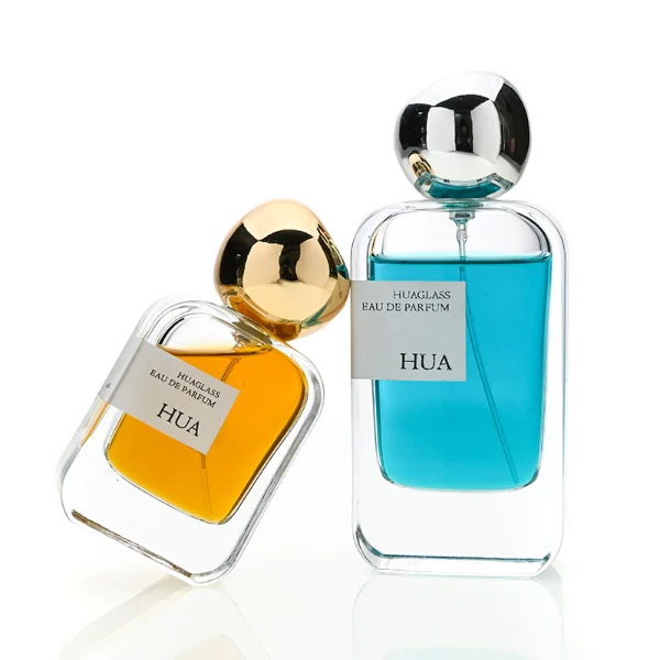 HUA0154 perfume bottle, rectangular clear glass body with 30 ml, 50 ml, or 100 ml liquid, irregular spherical plastic cap with customizable color, outer label with printed logo, modern elegant design, ideal for gifting and daily use.