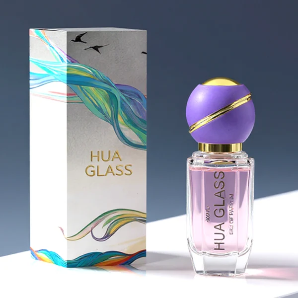 HUA0155 perfume bottle, cylindrical transparent glass body with 30 ml, 50 ml, or 100 ml liquid, spherical plastic cap with diagonal gold stripe, gold top, and gold metallic neck, outer label with printed logo, modern elegant design, ideal for gifting and daily use.