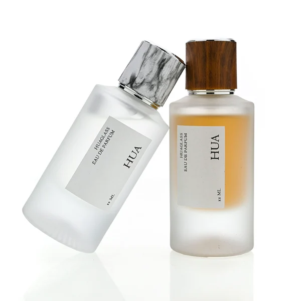HUA0159 perfume bottle, cylindrical frosted glass body with 30 ml or 50 ml liquid, cylindrical plastic cap with silver rings at both ends, water transfer printed logo, modern elegant design, ideal for gifting and daily use.