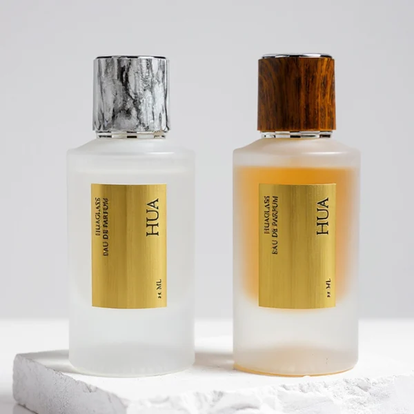 HUA0159 perfume bottle, cylindrical frosted glass body with 30 ml or 50 ml liquid, cylindrical plastic cap with silver rings at both ends, water transfer printed logo, modern elegant design, ideal for gifting and daily use.