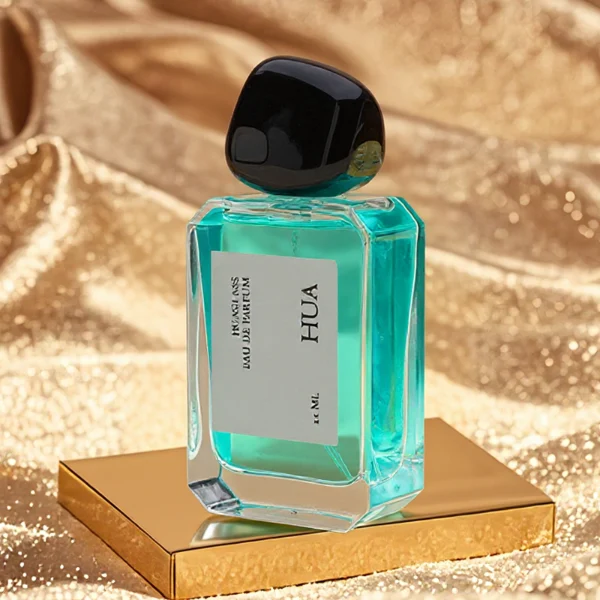 HUA0160 perfume bottle, rectangular clear glass body with 30 ml, 50 ml, or 100 ml liquid, irregular rounded plastic cap, outer label with printed logo, modern elegant design, ideal for gifting and daily use.
