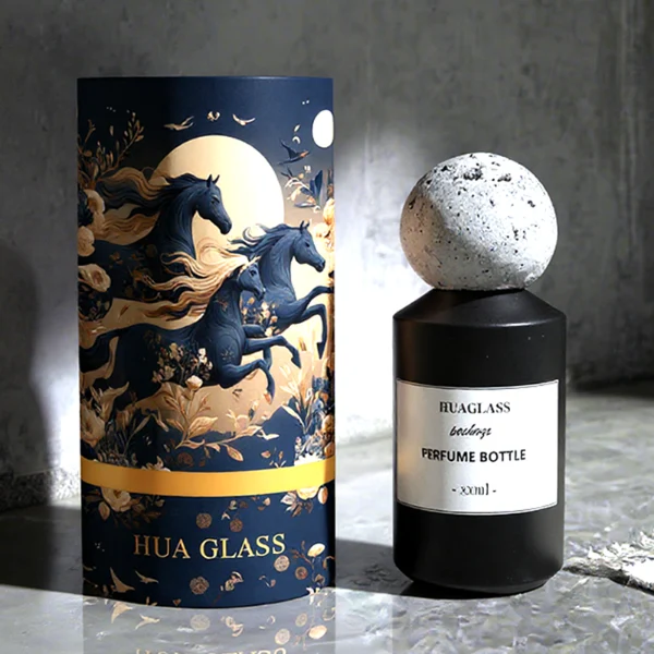 HUA0161 perfume bottle, cylindrical glass body with matte solid-color spray finish and 30 ml, 50 ml, or 100 ml liquid, spherical artificial stone cap, outer label with printed logo, modern elegant design, ideal for gifting and daily use.