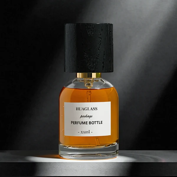 HUA0162 perfume bottle, cylindrical transparent glass body with 30 ml, 50 ml, or 100 ml liquid, tall cylindrical black wooden cap with gold metallic neck, outer label with printed logo, modern elegant design, ideal for gifting and daily use.