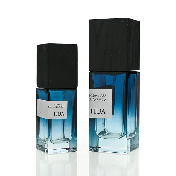 HUA0163 perfume bottle, rectangular gradient glass body with 30 ml, 50 ml, or 100 ml liquid, tall square wooden cap, outer label with printed logo, modern elegant design, ideal for gifting and daily use.