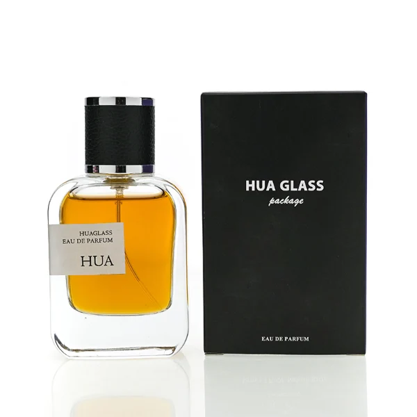 HUA0165 perfume bottle, rectangular transparent glass body with 30 ml, 50 ml, or 100 ml liquid, cylindrical plastic cap wrapped in leather with gold metallic neck, outer label with printed logo, modern elegant design, ideal for gifting and daily use.