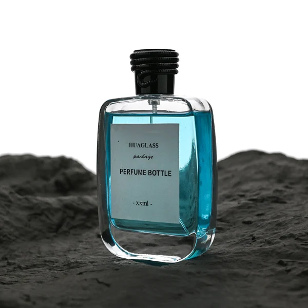 HUA0166 perfume bottle, rectangular transparent glass body with 30 ml, 50 ml, or 100 ml liquid, cylindrical plastic cap with rope-patterned detailing at the top in black or gold, outer label with printed logo, modern elegant design, ideal for gifting and daily use.