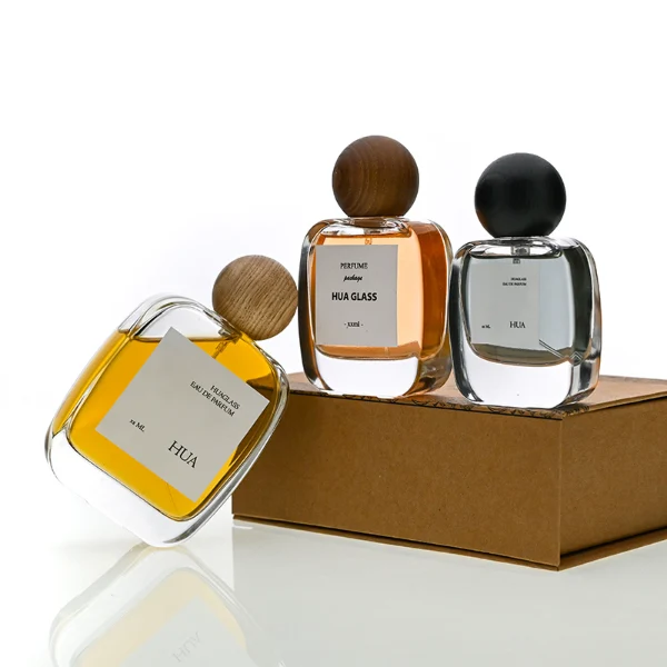 HUA0168 perfume bottle, rectangular transparent glass body with 30 ml, 50 ml, or 100 ml liquid, spherical wooden cap, outer label with printed logo, modern natural elegant design, ideal for gifting and daily use.