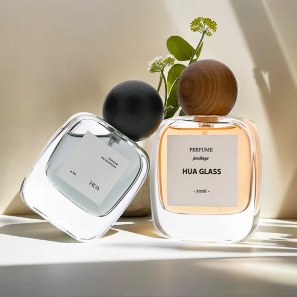 HUA0168 perfume bottle, rectangular transparent glass body with 30 ml, 50 ml, or 100 ml liquid, spherical wooden cap, outer label with printed logo, modern natural elegant design, ideal for gifting and daily use.
