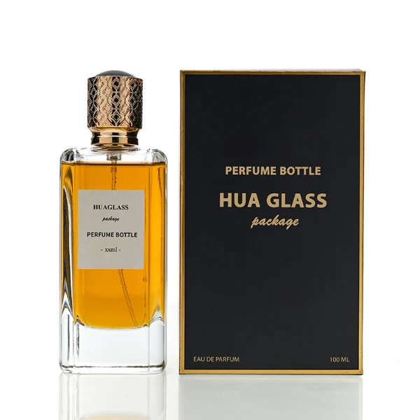 HUA0170 perfume bottle, rectangular transparent glass body with 50 ml or 80 ml liquid, cylindrical plastic cap with engraved decorative pattern and gold neck ring, outer label with printed logo, modern luxurious design, ideal for gifting and daily use.