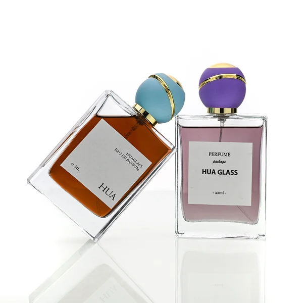 HUA0171 perfume bottle, rectangular transparent glass body with 30 ml, 50 ml, or 100 ml liquid, spherical plastic cap with diagonal gold stripe detailing and gold neck ring, outer label with printed logo, modern elegant design, ideal for gifting and daily use.