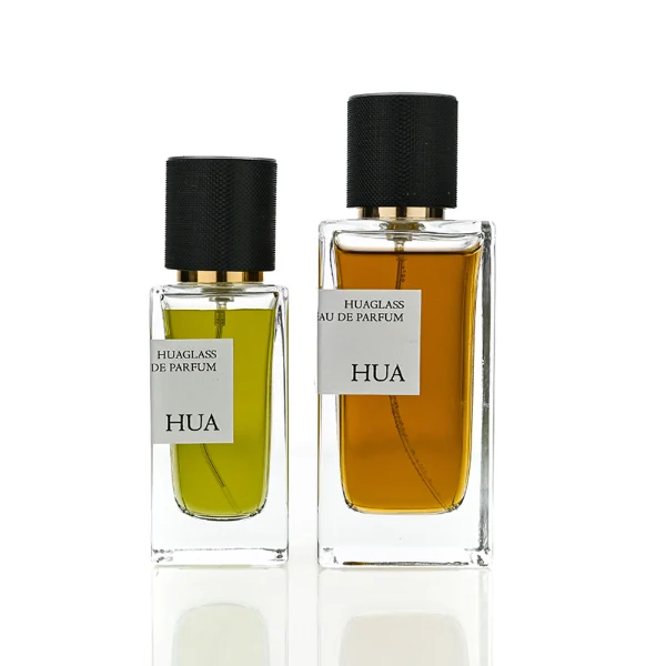 HUA0172 perfume bottle, rectangular transparent glass body with 30 ml, 50 ml, or 100 ml liquid, smooth black cylindrical plastic cap with gold sprayer and gold neck ring, outer label with printed logo, modern minimalist design, ideal for gifting and daily use.