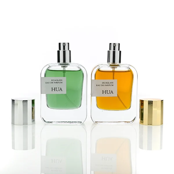 HUA0175 perfume bottle, rectangular transparent glass body with 30 ml, 50 ml, or 100 ml liquid, glossy cylindrical plastic cap in gold or silver color, printed logo label, modern minimalist luxury design, ideal for gifting and daily use.
