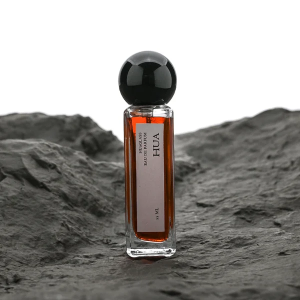 HUA0177 perfume bottle, slim rectangular transparent glass body with 30 ml, 50 ml, or 100 ml liquid, glossy spherical plastic cap with customizable colors, printed vertical logo label, modern minimalist elegant design, ideal for gifting and daily use.