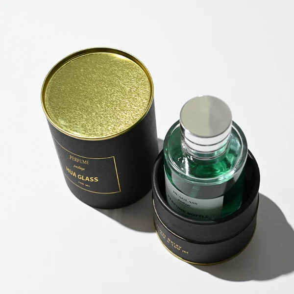 HUA0178 perfume bottle, cylindrical transparent glass body with embossed radial base pattern, 30 ml, 50 ml, or 100 ml liquid, stopper-style cylindrical plastic cap with customizable colors, printed logo label, modern luxury minimalist design, ideal for gifting and daily use.