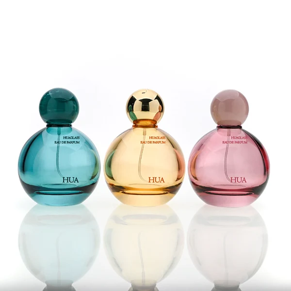 HUA0180 perfume bottle, round gourd-shaped glass body with customizable transparent colors, 30 ml, 50 ml, or 100 ml liquid, glossy spherical plastic cap with customizable colors, custom printed logo, modern playful elegant design, ideal for gifting and daily use.