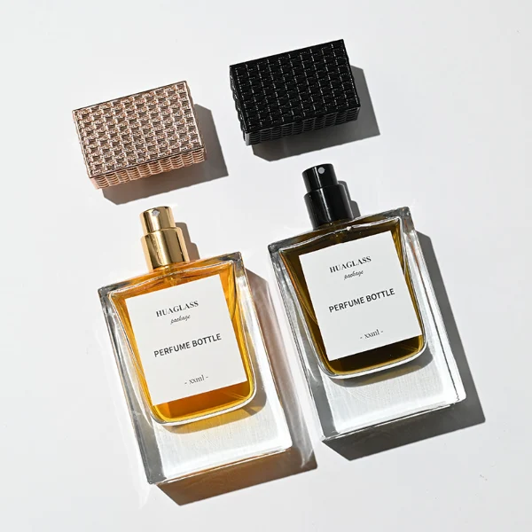 HUA0189 perfume bottle, rectangular transparent glass body with 50 ml liquid, rectangular textured plastic cap with customizable color matching the neck, printed logo label, modern premium luxury design, ideal for gifting and daily use.