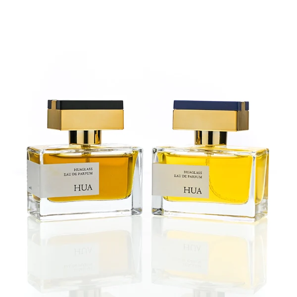 HUA0190 perfume bottle, rectangular transparent glass body with 50 ml liquid, rectangular plastic cap with customizable color matching the neck, printed logo label, modern premium luxury design, ideal for gifting and daily use.
