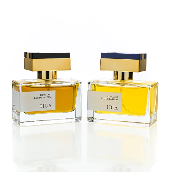 HUA0190 perfume bottle, rectangular transparent glass body with 50 ml liquid, rectangular plastic cap with customizable color matching the neck, printed logo label, modern premium luxury design, ideal for gifting and daily use.