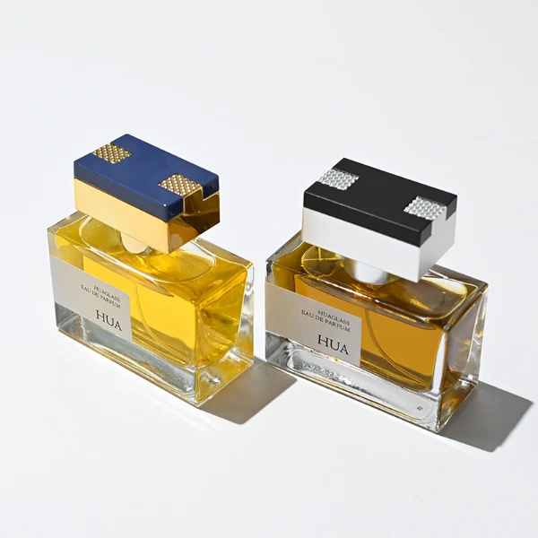 HUA0190 perfume bottle, rectangular transparent glass body with 50 ml liquid, rectangular plastic cap with customizable color matching the neck, printed logo label, modern premium luxury design, ideal for gifting and daily use.