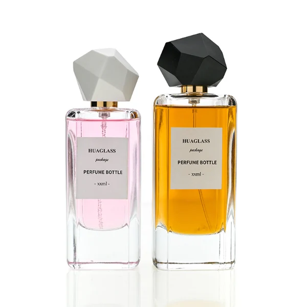 HUA0192 perfume bottle, rectangular transparent glass body with 50 ml or 80 ml liquid, irregular faceted geometric plastic cap with gold neck, printed logo label, modern artistic luxury design, ideal for gifting and daily use.