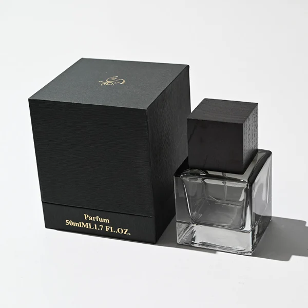 HUA0199 perfume bottle, square gradient glass body with 30 ml, 50 ml, or 100 ml liquid, black wooden square cap with removable design, one with gold spray head, one with protective cap, printed logo label, modern minimalist luxury design, ideal for gifting and daily use.
