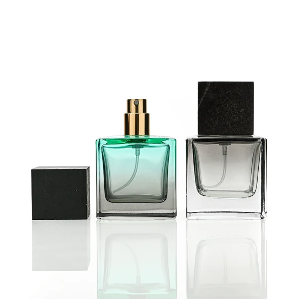 HUA0199 perfume bottle, square gradient glass body with 30 ml, 50 ml, or 100 ml liquid, black wooden square cap with removable design, one with gold spray head, one with protective cap, printed logo label, modern minimalist luxury design, ideal for gifting and daily use.