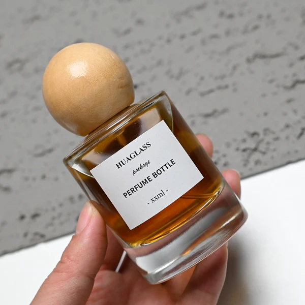 HUA0200 perfume bottle, cylindrical matte solid-color sprayed glass body with 30 ml, 50 ml, or 100 ml liquid, spherical resin cap with marble pattern, private printed logo, modern luxurious design, ideal for gifting and daily use.
