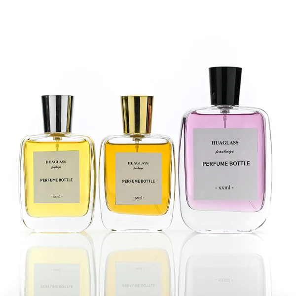 HUA0202 perfume bottle, rectangular transparent glass body with 50 ml or 100 ml liquid, stepped cylindrical plastic cap in black, gold, or silver, brand label applied on the surface, modern minimalist design, ideal for gifting and daily use.