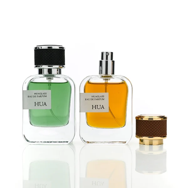 HUA0207 perfume bottle, rectangular transparent glass body with thick base, 30 ml, 50 ml, or 100 ml liquid, cylindrical leather-wrapped cap with customizable colors, brand label applied on the surface, modern luxurious design, ideal for gifting and daily use.