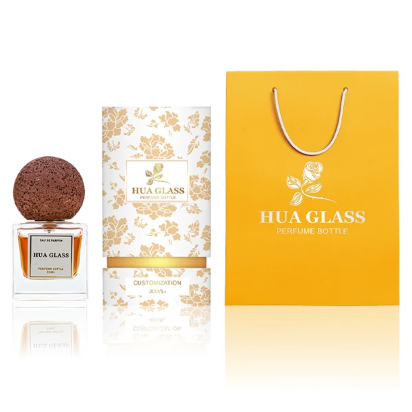 HUA0210 perfume bottle, square transparent glass body with thick base, 30 ml, 50 ml, or 100 ml liquid, spherical artificial stone cap with textured surface, brand label applied on the surface, modern artistic luxury design, ideal for gifting and daily use.