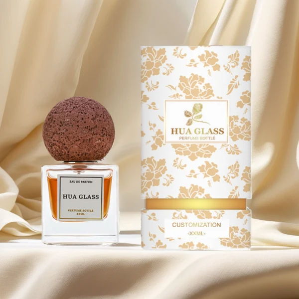 HUA0210 perfume bottle, square transparent glass body with thick base, 30 ml, 50 ml, or 100 ml liquid, spherical artificial stone cap with textured surface, brand label applied on the surface, modern artistic luxury design, ideal for gifting and daily use.