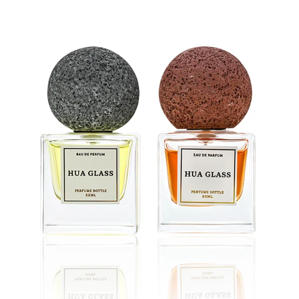 HUA0210 perfume bottle, square transparent glass body with thick base, 30 ml, 50 ml, or 100 ml liquid, spherical artificial stone cap with textured surface, brand label applied on the surface, modern artistic luxury design, ideal for gifting and daily use.