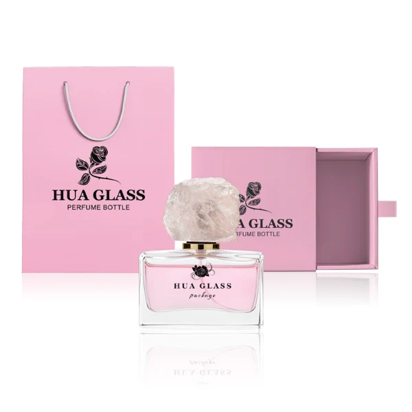 HUA0211 perfume bottle, rectangular customizable glass body with thick base, 30 ml, 50 ml, or 100 ml liquid, rough natural crystal stone cap with gold metallic neck, brand label printed on the surface, modern artistic luxury design, ideal for gifting and daily use.
