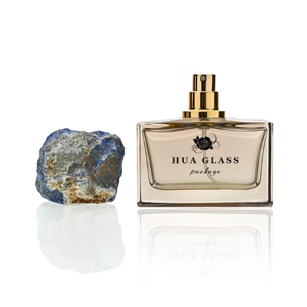 HUA0211 perfume bottle, rectangular customizable glass body with thick base, 30 ml, 50 ml, or 100 ml liquid, rough natural crystal stone cap with gold metallic neck, brand label printed on the surface, modern artistic luxury design, ideal for gifting and daily use.