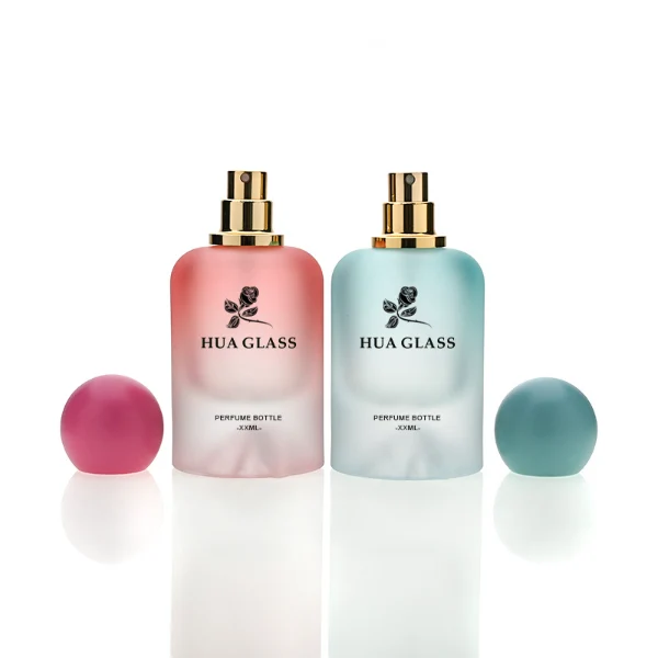 HUA0212 perfume bottle, rounded cylindrical frosted glass body with thick base, 30 ml, 50 ml, or 100 ml liquid, spherical plastic cap in customizable colors with gold neck ring, brand logo printed on the bottle, modern playful luxury design, ideal for gifting and daily use.