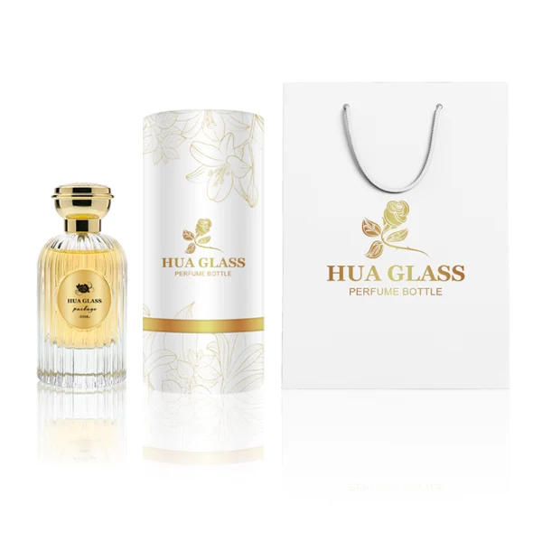 HUA0216 perfume bottle, ribbed transparent glass body with thick base, 50 ml or 100 ml liquid, cylindrical plastic cap with wave-shaped or slightly domed top with decorative grooves, metallic finish, gold logo label applied on bottle, modern luxurious fashion design, ideal for gifting and daily use.
