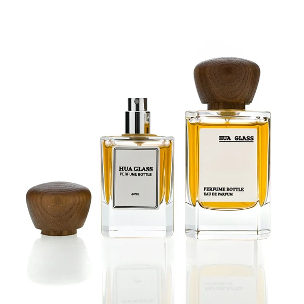 HUA0217 perfume bottle, square transparent glass body with thick base, 30 ml, 50 ml, or 100 ml liquid, rounded wooden cap, brand label applied on bottle, modern luxurious fashion design, ideal for gifting and daily use.